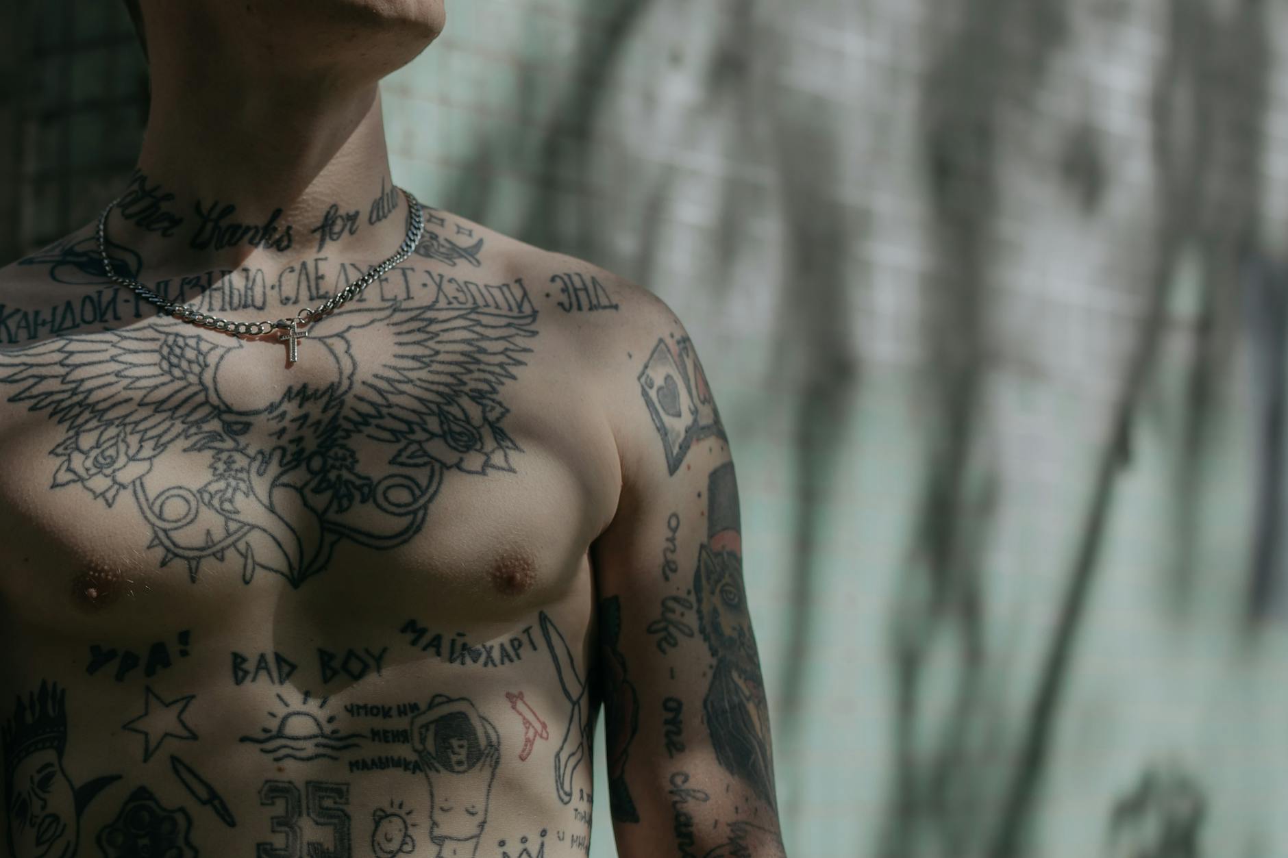 close up shot of a man s chest with tattoo